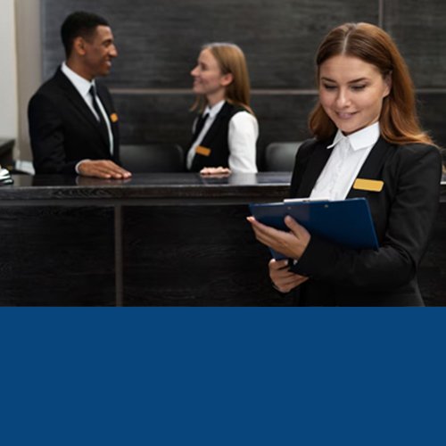 Hotel reception staff in uniform at a front desk