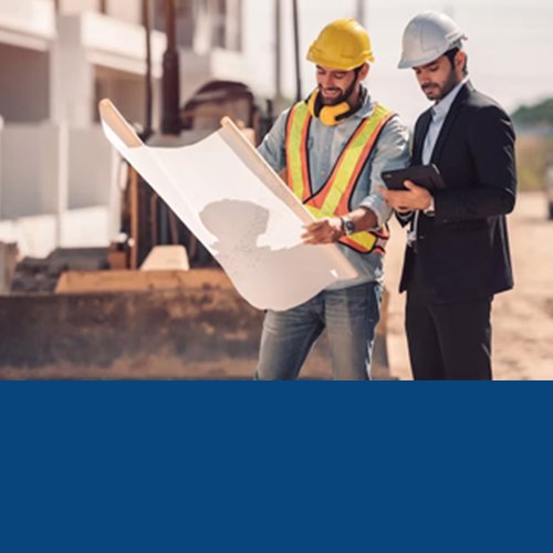 Two engineers in hard hats reviewing blueprints on site