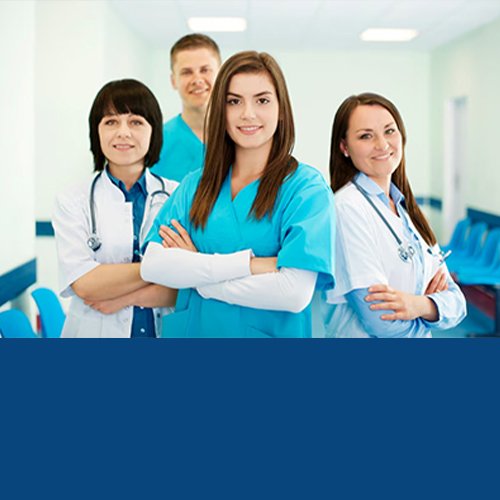Group of smiling medical students in scrubs and white coats